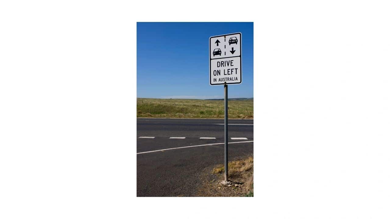 How to adapt easily to working in a new country, an Australian road sign saying drive on the left in Australia