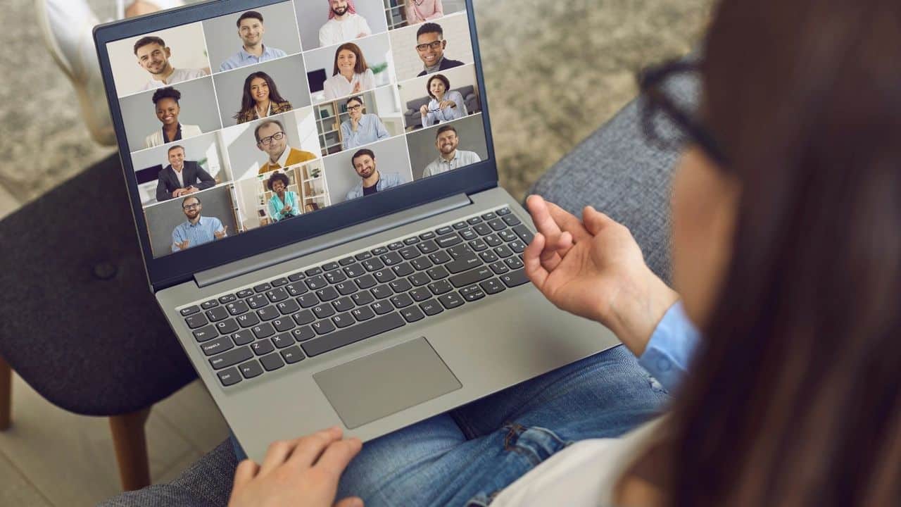 Woman having online video conference with 16 colleagues