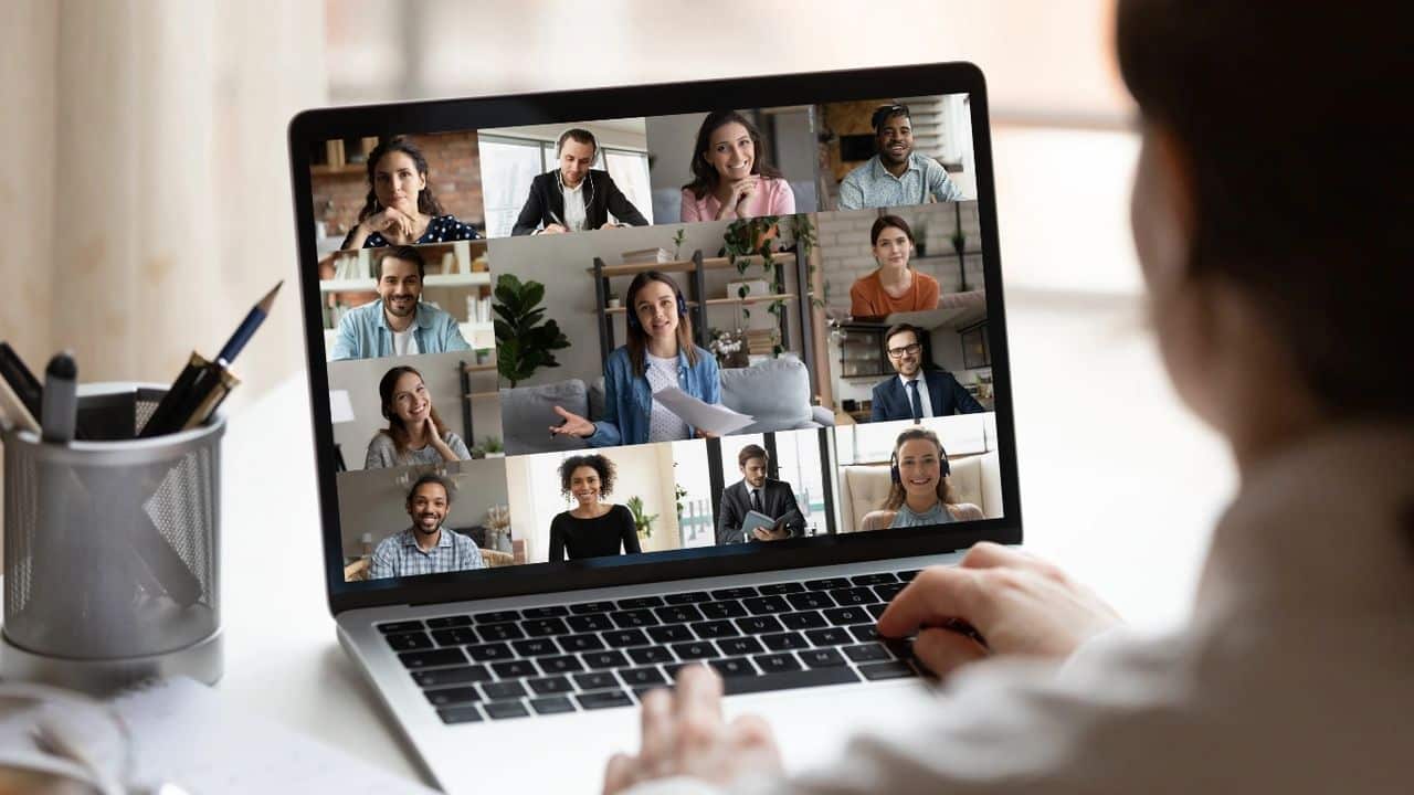 person looking at screen of laptop on a zoom call
