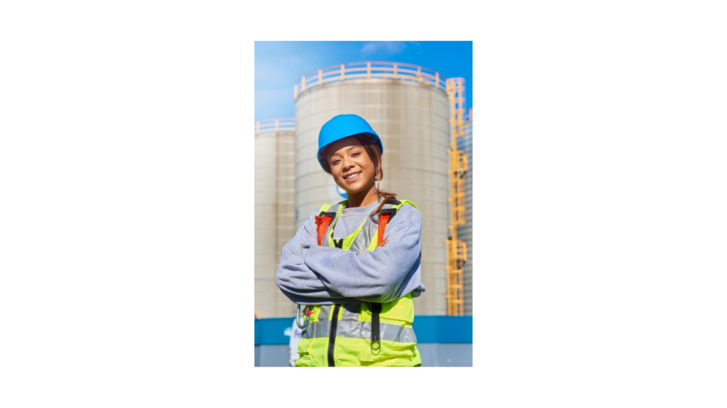 woman service engineer in ppe standing by cooling tower - example of great service engineer