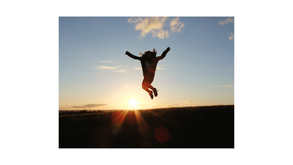 happy person jumping at sunrise