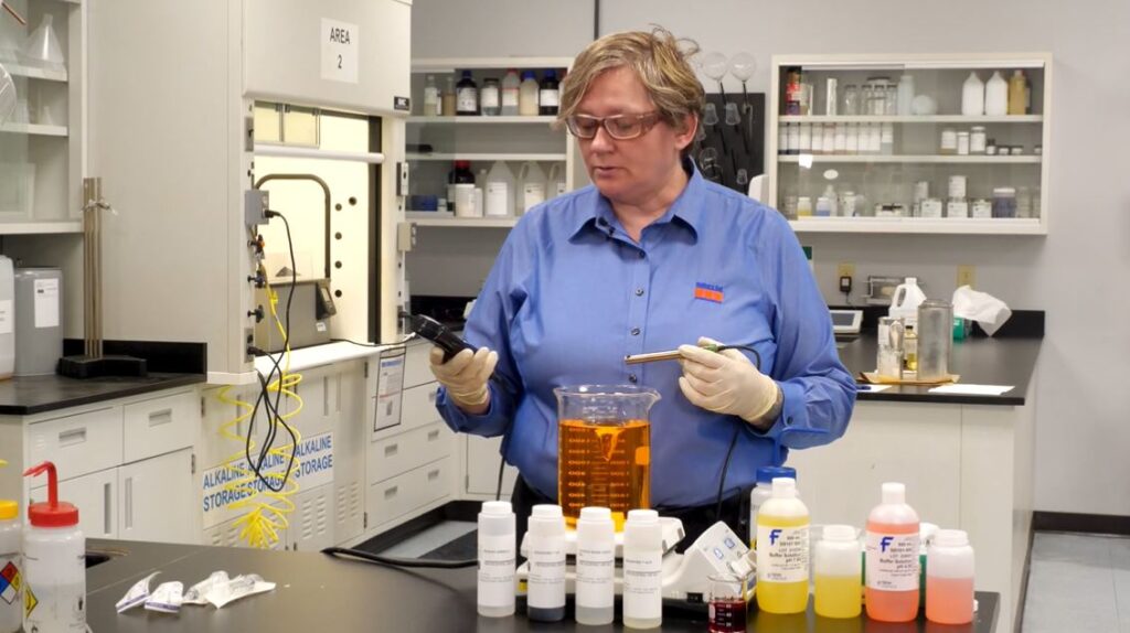 Robin Deal in lab with chemicals, leading a team to keep our rivers clean