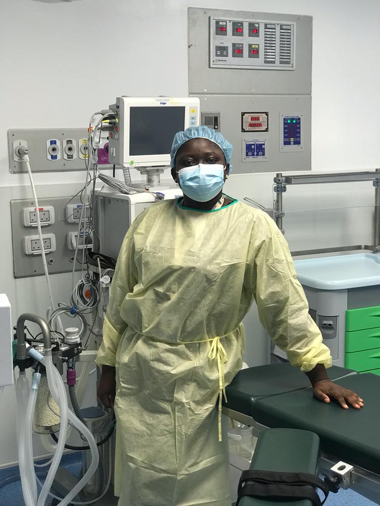 Beatrice Yeboah in PPE in front of equipment