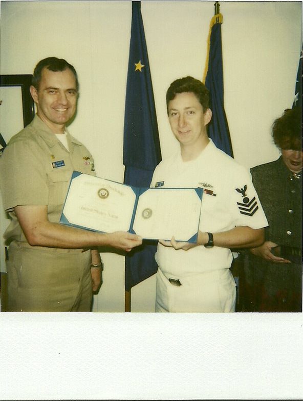 Jonathan Haymans with Commanding Officer receiving an award