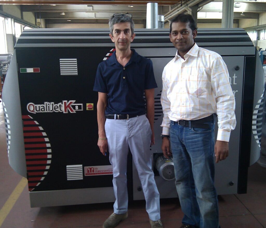 Navid Raza with colleague in front of printer