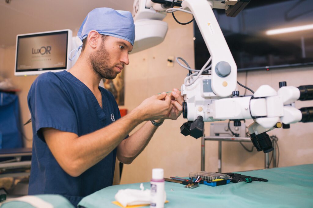 Guido Kortleven, working as aSenior Biomedical Tech, cleaning a microscope in the OR.