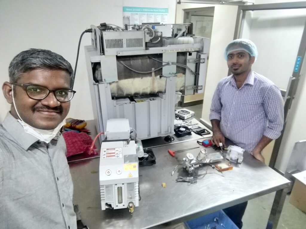 Sivakumar Field Service Engineer in India with colleague at work bench