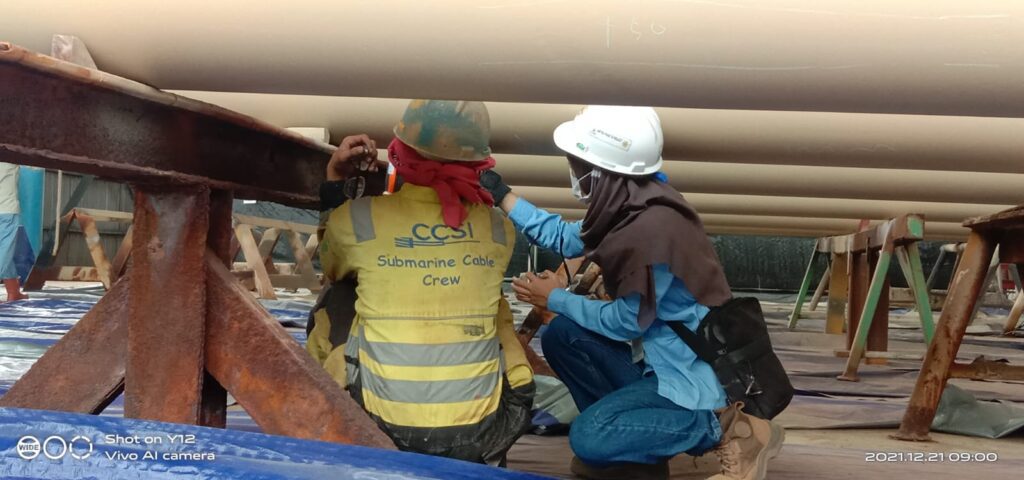 Alfina Nurul Haqoh working on pipes
