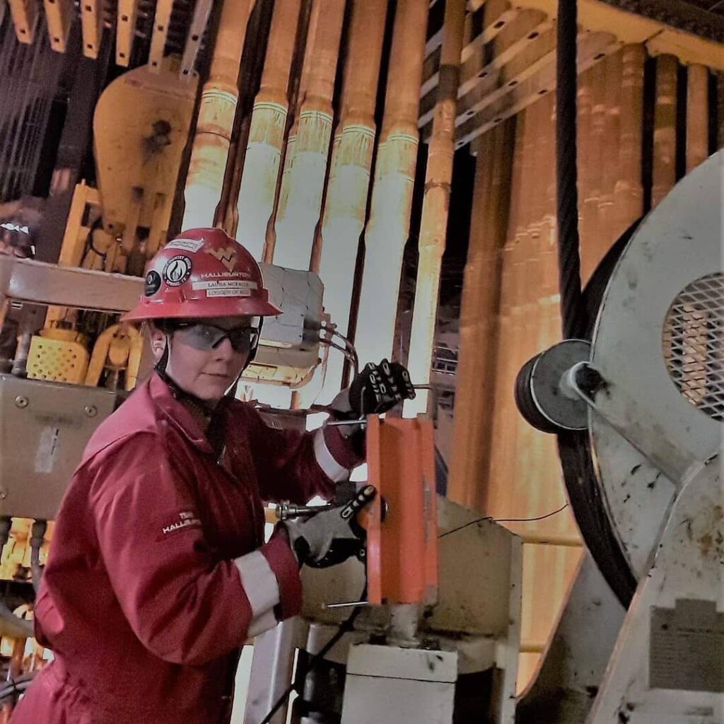 Laura McFalls in hard hat with machinery working in Real-Time Operations