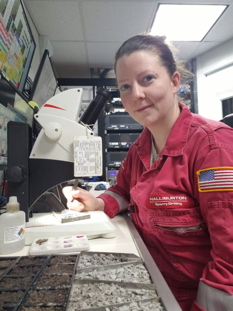 Laura McFalls in lab with rock samples working in Real-Time Operations