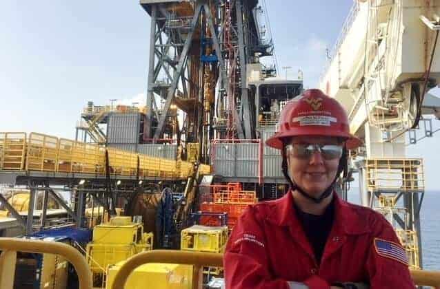 Laura McFalls on oil rig in hard hat working in Real-Time Operations