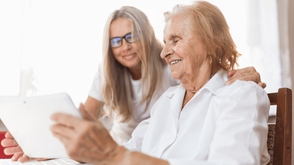 elderly woman and younger woman with tablet