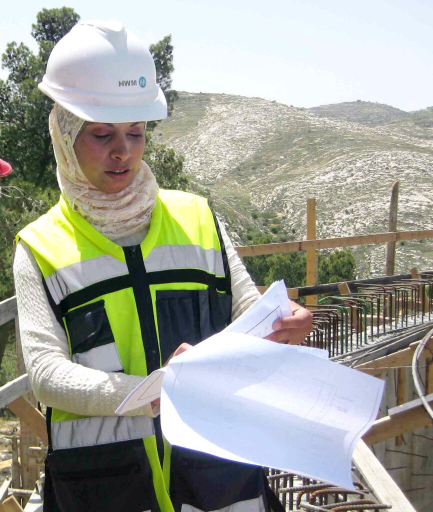 Female engineer on construction site
in headscarf under hard hat 
unconscious bias example