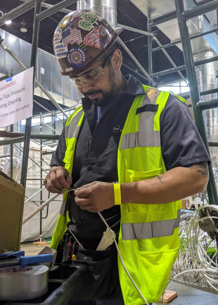 engineer with cable and tools in factory