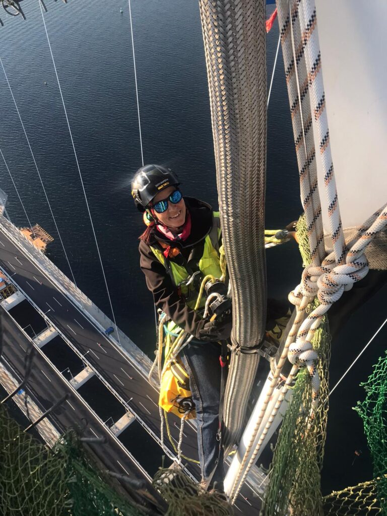 Adalet Yurtcu Rope Access Technician on ropes above bridge
