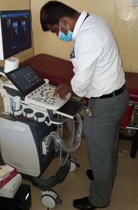 Anand Dalvi Senior Biomedical Engineer installing a scanner