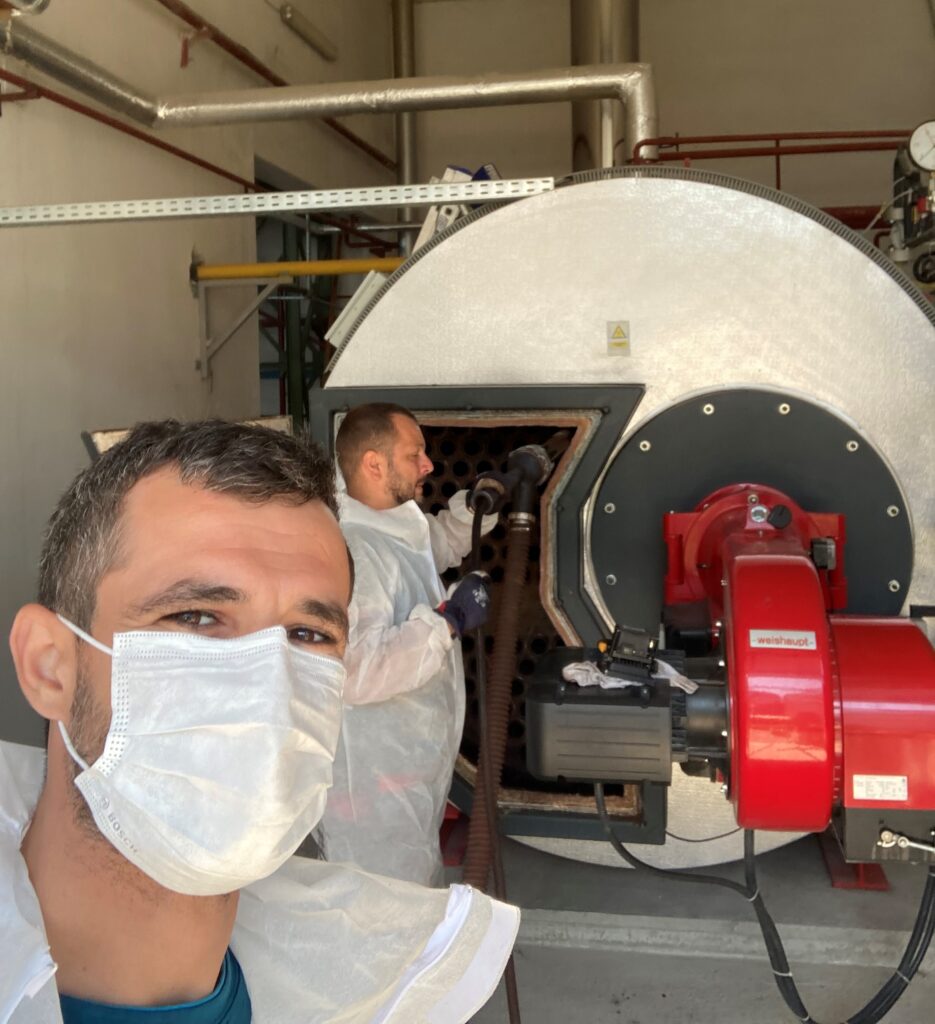 Andrei Moldoveanu Field Services Engineer at Robert Bosch TT with colleague fixing boiler in pppe