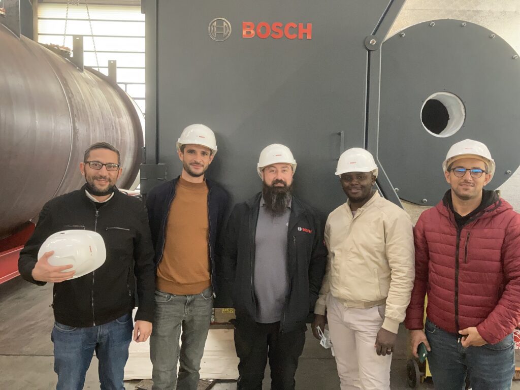Andrei Moldoveanu  with colleagues in front of Bosch equipment