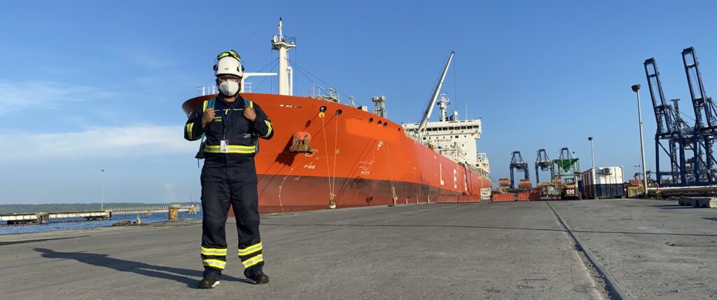 Arturo Gonzalez Alfa Laval Service Engineer by ship on quay in ppe