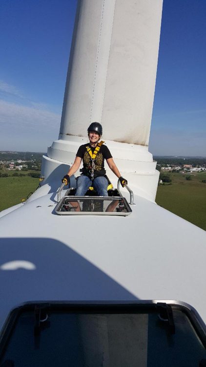 Jessie Moffitt, Wind Turbine Technician for Fairwind on turbine in sunshine