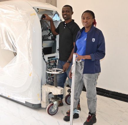 Philips Field Service Engineer Ruth Otieno with colleague and equipment