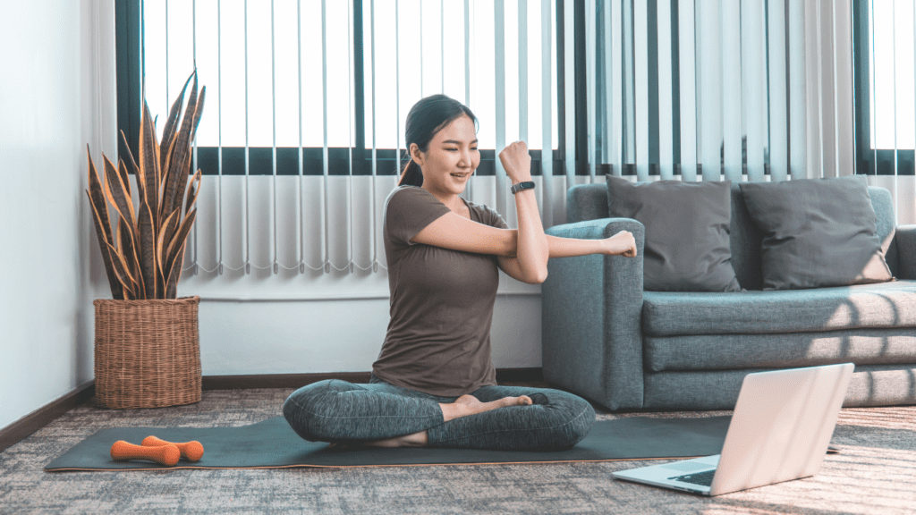 woman exercising at home with laptop - the benefits of remote-first