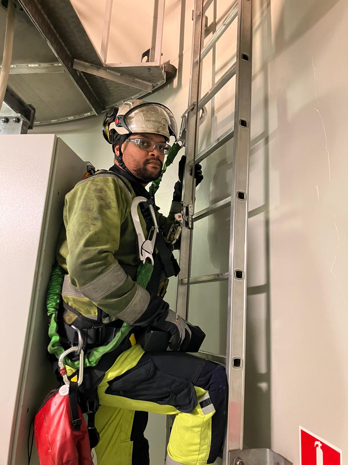 Clayton Topkin on ladder inside offshore Wind Turbine