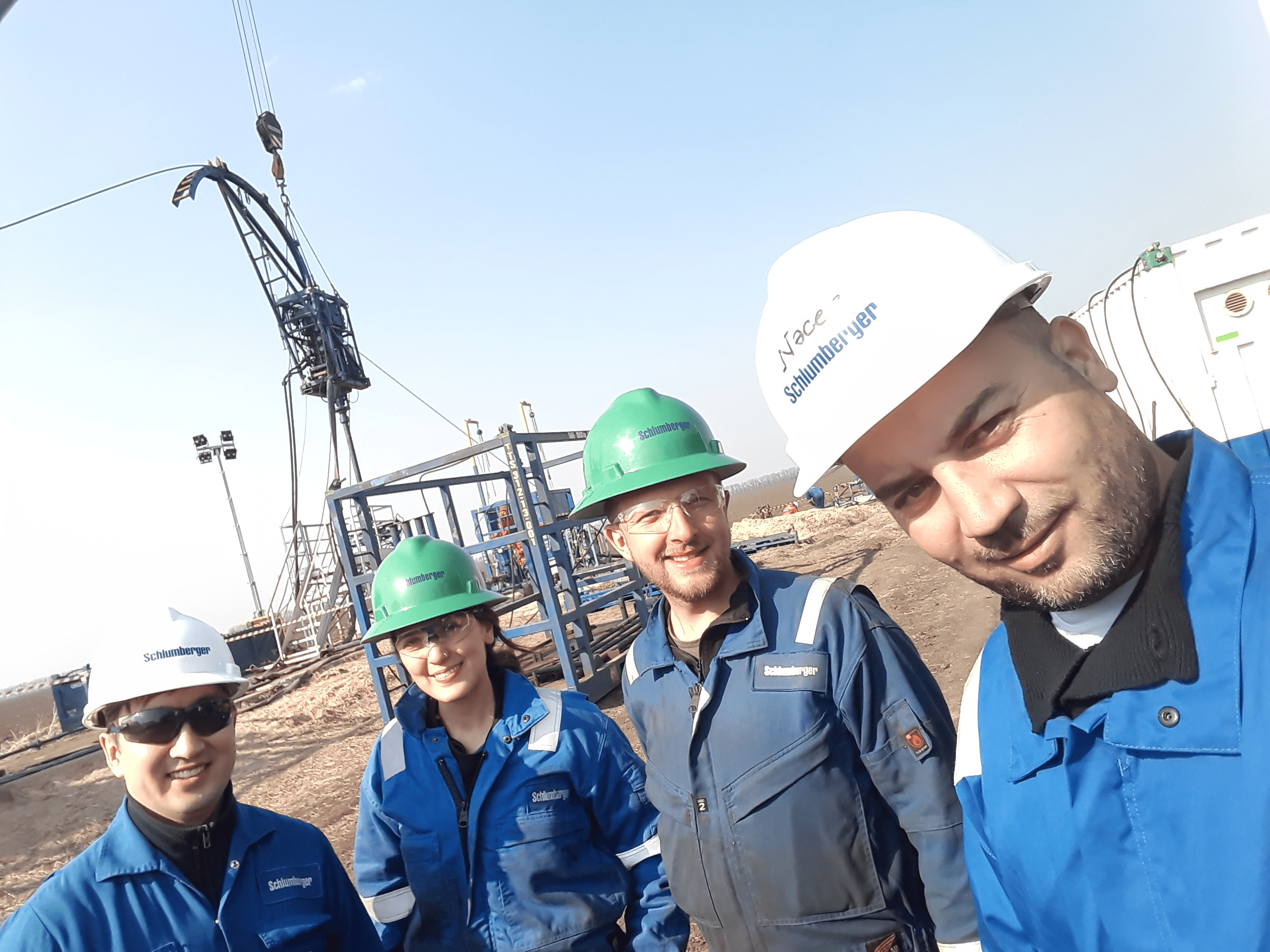 Yerik Balabatyr on oilfield in Ukraine with manager and two trainees