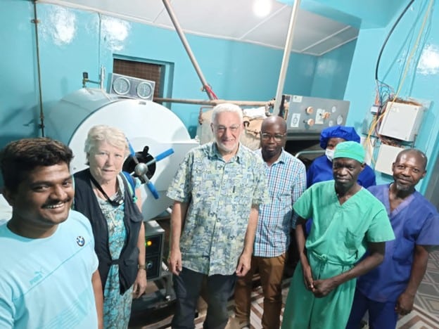 Anand Dalvi with colleagues working on sterilisation equipment