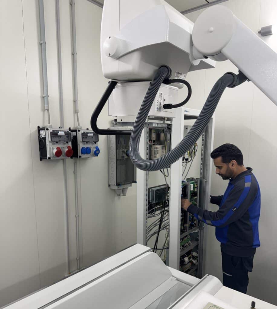 Varun Sharma field service engineer working on equipment and focusing on radiation safety