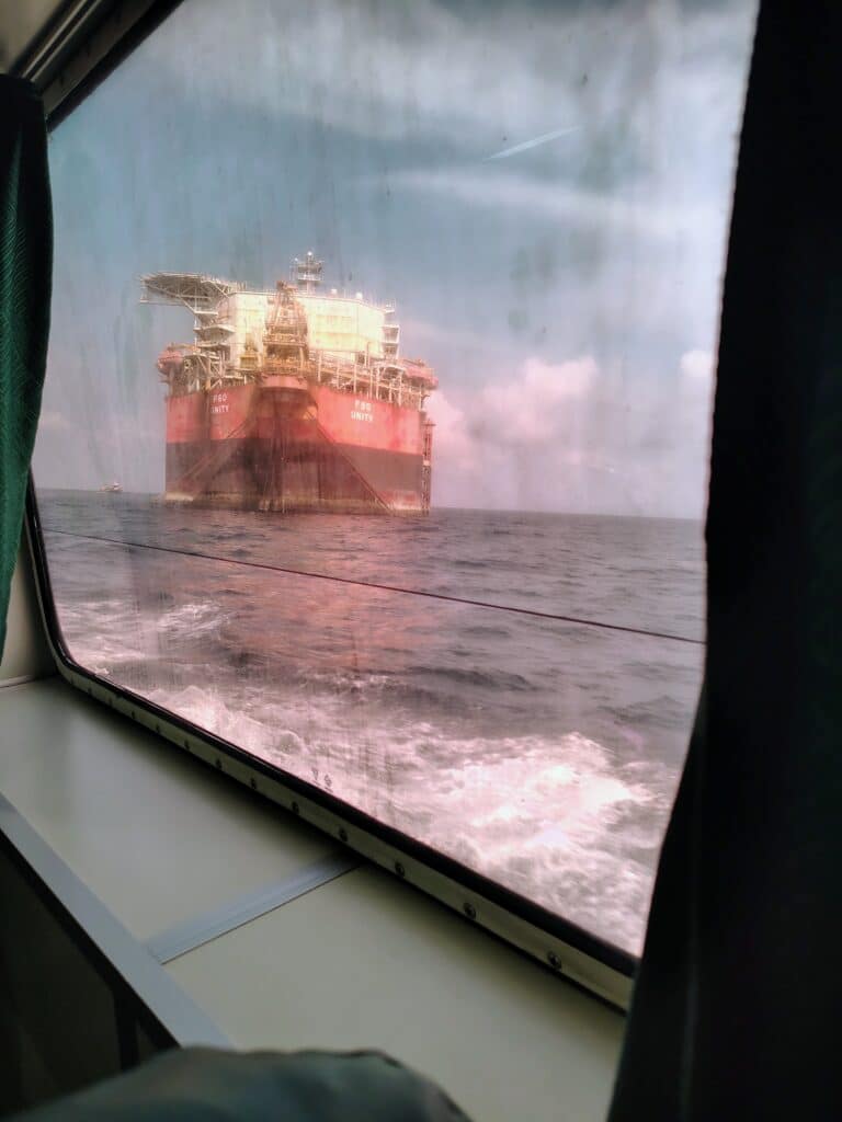 a biomedical engineer working offshore fixing medical equipment view from window