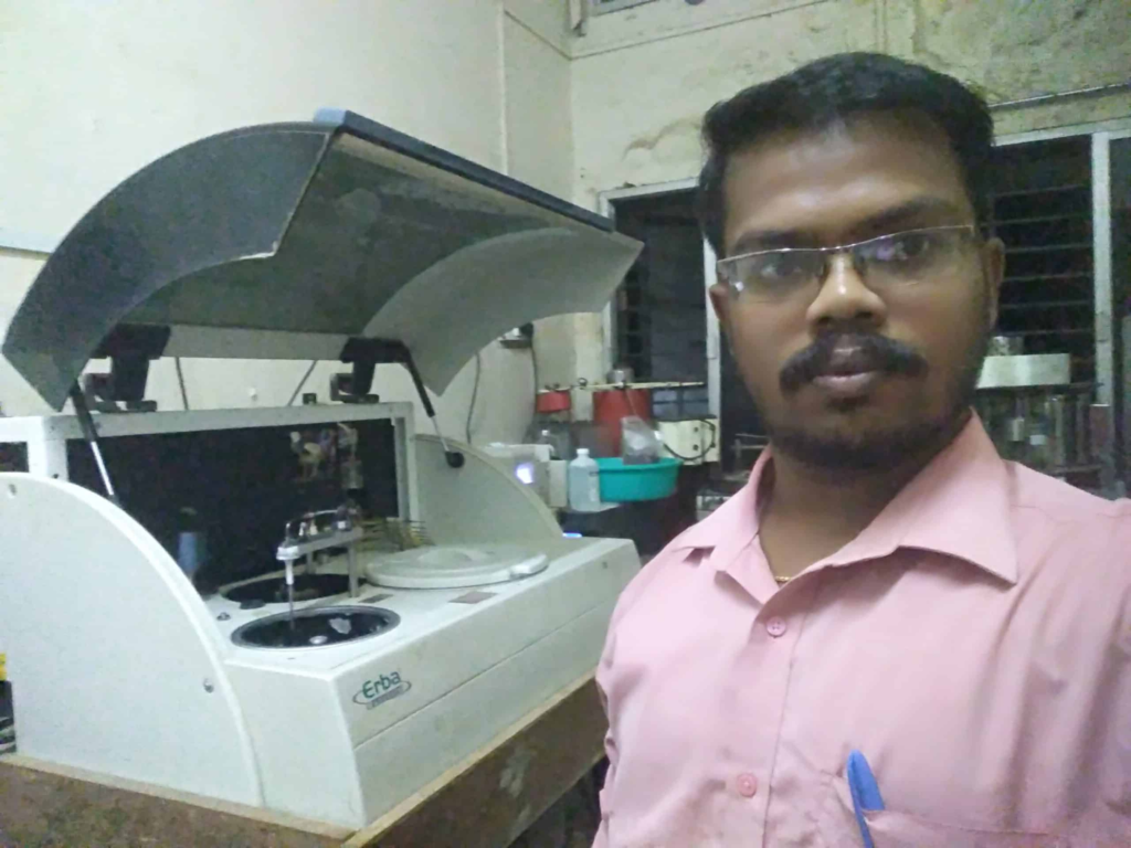 Gowthaman Balu working in a lab with with Erba biomedical equipment