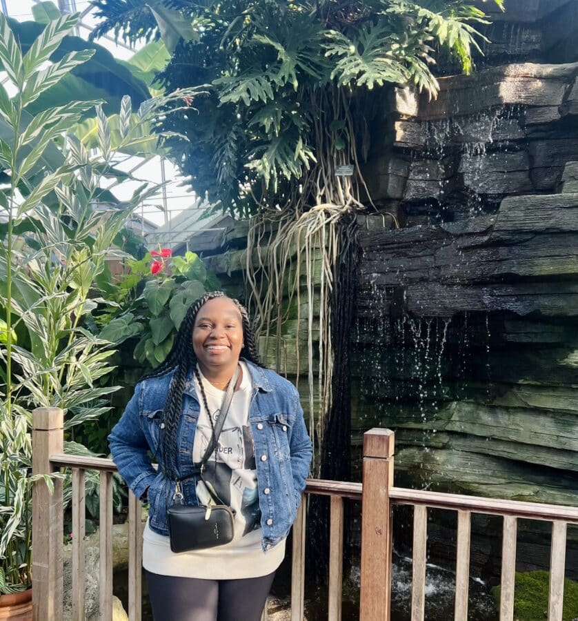 Tiffany Nungari Advanced Field Service Engineer by a waterfall