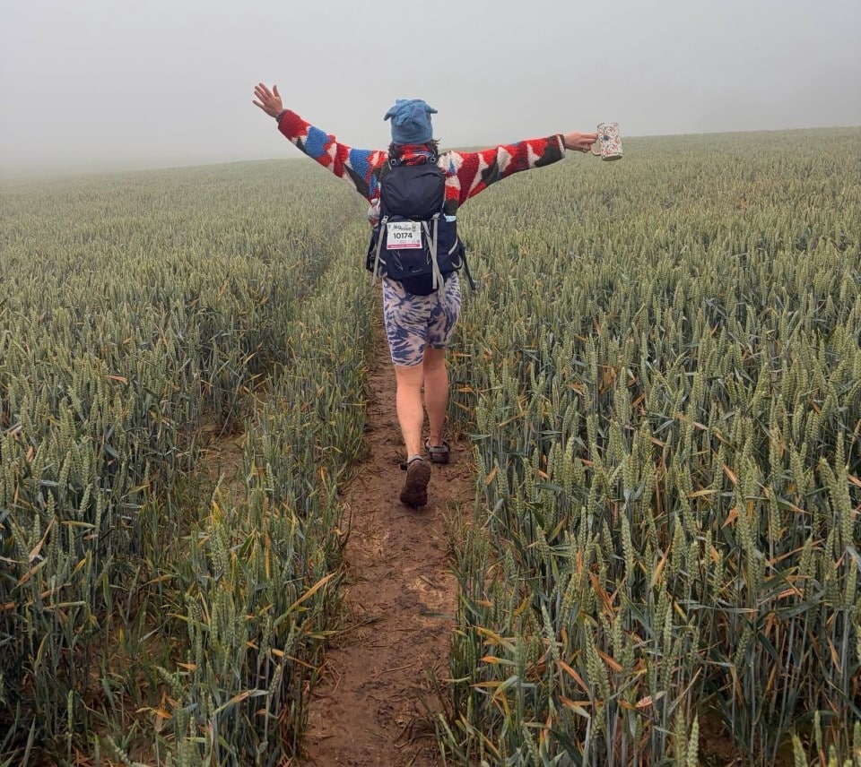 Tamsin Jordan Biotechnology Field Service Engineer hiking the Jurassic coast for cancer relief in a field